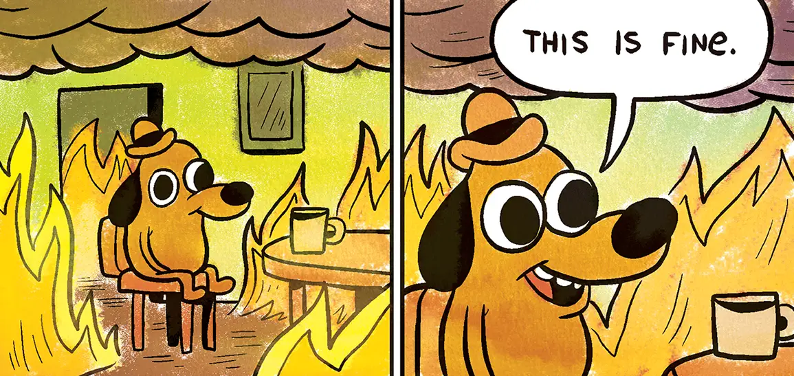 Cartoon dog in a hat sitting at a table in a burning room, saying "This is fine."